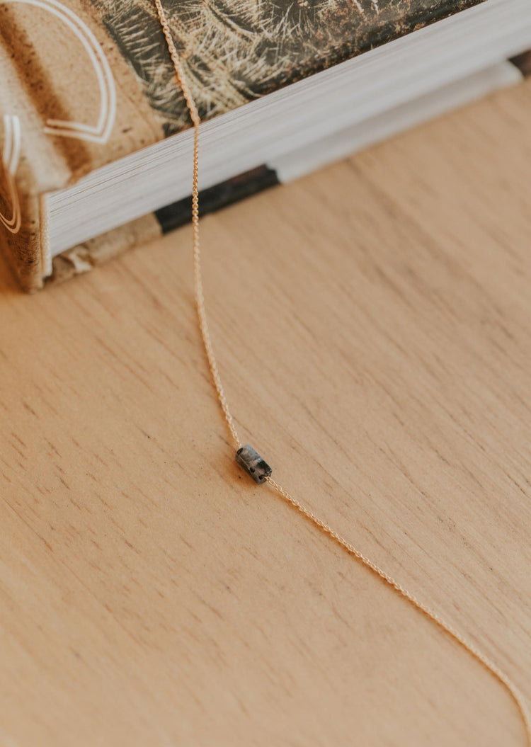 A black stone necklace in labradorite black from Hello Adorn in the Tiny Gemma Necklace style, part of the gemstone jewelry collection.