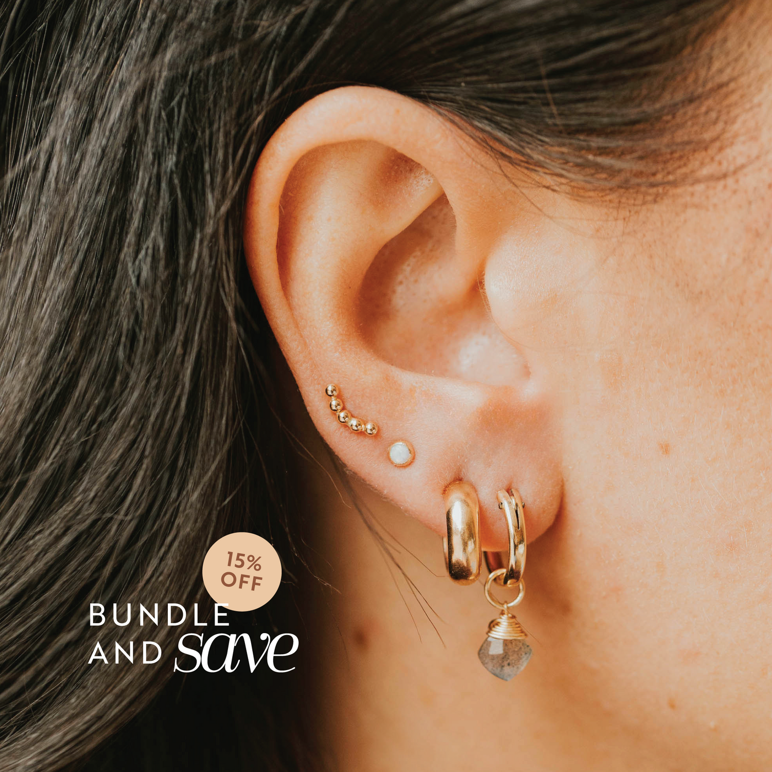 Close-up of an ear with gold earrings and a promotional text overlay for bundle and save offer.