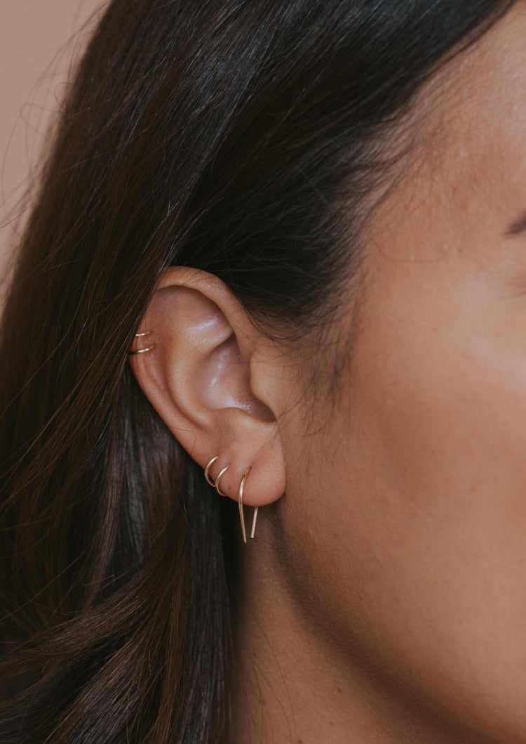 14k gold fill tiny horseshoe threader earrings styled with double up cuff and twist earrings by Hello Adorn