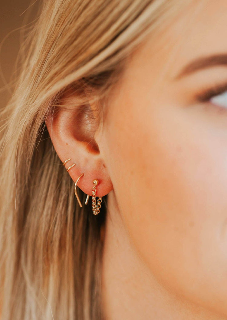 Earrings with hanging chain in Mini Annex Style by Hello Adorn styled with a horseshoe threader earring and double up post 14k gold fill earrings.