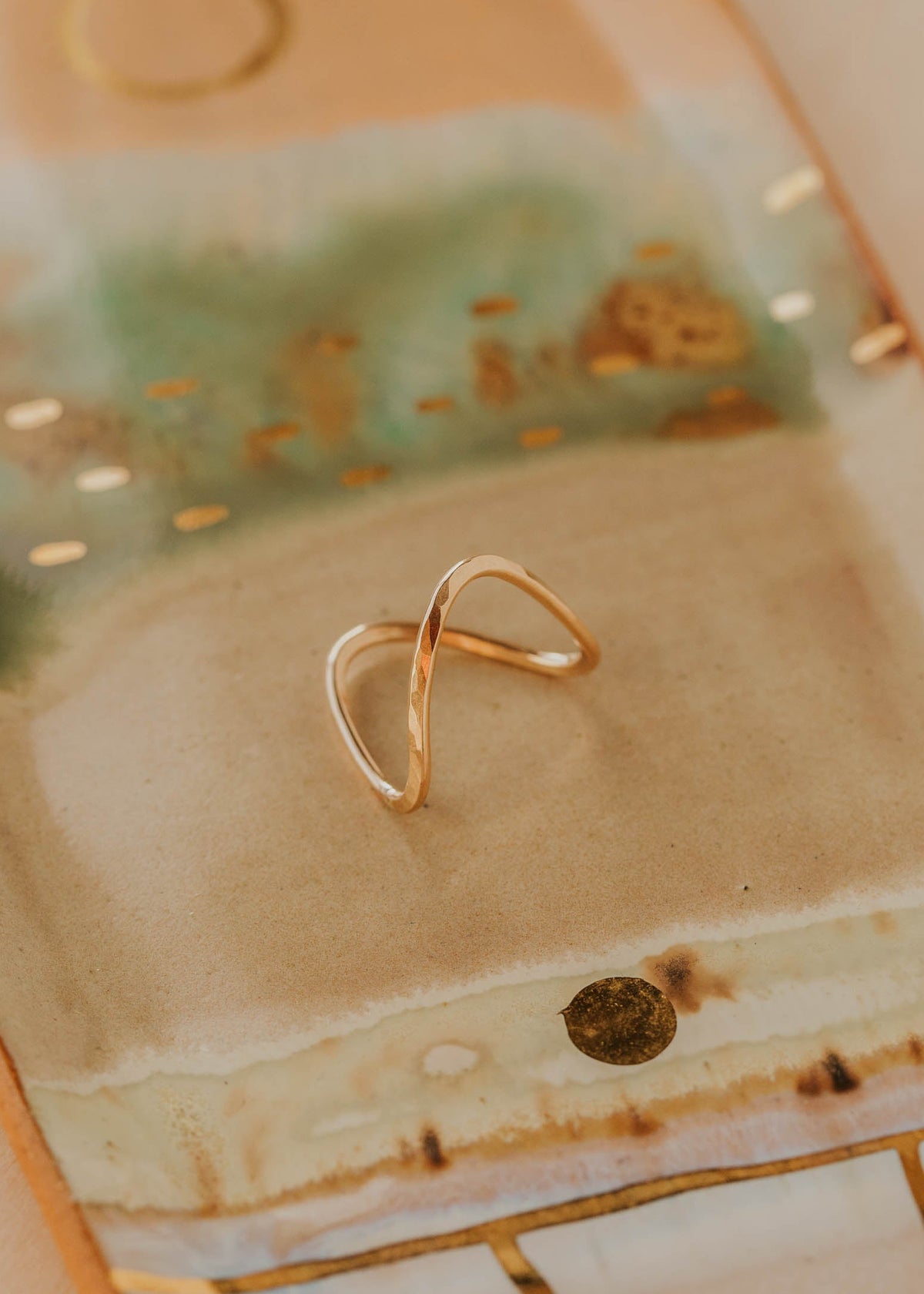 Gold ring on a textured ceramic surface