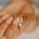Close-up of a person holding rings with a blurred background
