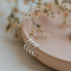 Earrings that look like 2 piercings shown in sterling silver by Hello Adorn in double up post style.