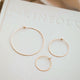 Thin hoop earrings in Cypress Hoops design created by Hello Adorn in three different sizes of hoops, a small hoop earring, medium hoop earring, and large hoop earring for everyday jewelry.