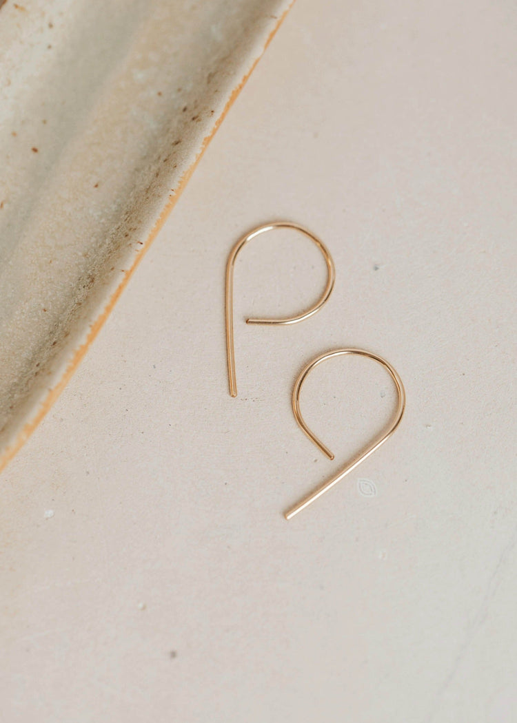 A pair of gold threader earrings hand-shaped by Hello Adorn to turn wire earrings into half hoop earrings in the MINI Swoops design.