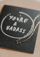 you're a badass card with uterus necklace flat lay
