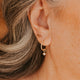14K Gold Fill Grace Charms by Hello Adorn - CZ star charm huggie worn in model's ear close-up