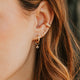 14K Gold Fill Grace Charms by Hello Adorn - CZ charm huggie earring worn in model's ear with curated stack