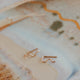 14k gold fill wavy ear climber earrings by Hello Adorn laid on an artistic ceramic tray