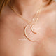 Two statement necklaces with moon pendants attached to a chain necklace, two crescent moon necklaces in a small pendant style and a large pendant style handmade by Hello Adorn.