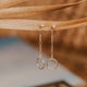 A pair of dangle earrings created by Hello Adorn in the Monday Backdrop design, a behind ear earrings pair that combines a chain drop earring with a circle drop earring.