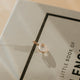 Gold pendant on a Balenciaga book