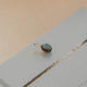 Gold pendant with a labradorite gemstone on a book
