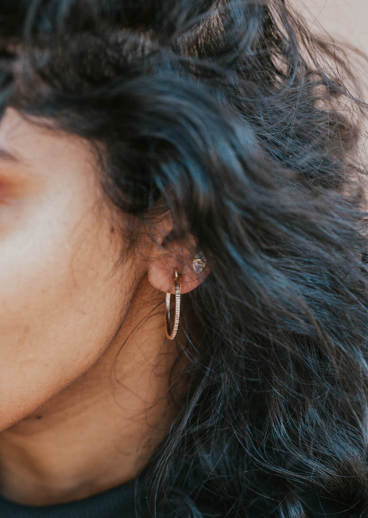 model black hair wearing 14kt gold fill hoop earrings