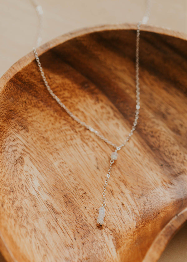 Necklace with a pendant on a wooden dish