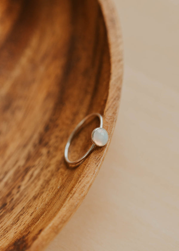 Silver ring on a wooden surface