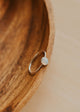 Silver ring on a wooden surface