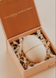 Wooden egg-shaped object in a gift box with 'I'm so happy you're my person' text.