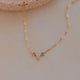 Gold necklace on a neutral background