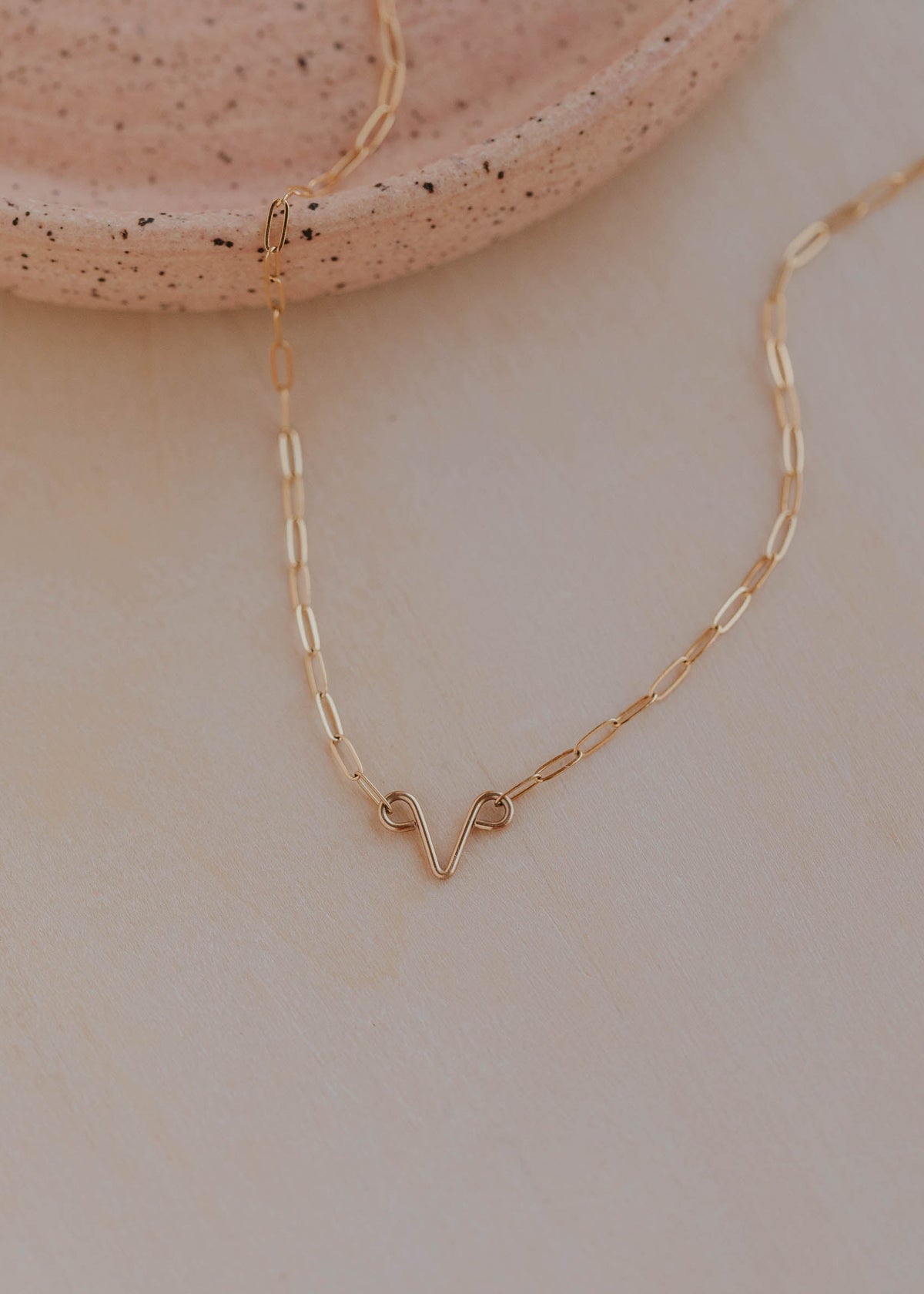 Gold necklace on a neutral background