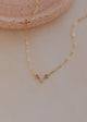 Gold necklace on a neutral background