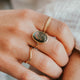 Close-up of two hands holding each other with visible jewelry.