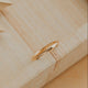 Gold ring on a wooden surface