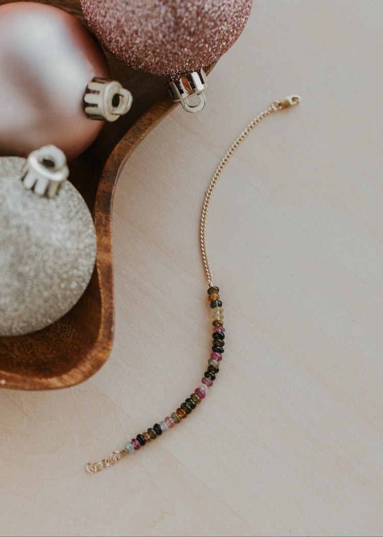 Beaded bracelet with colorful stones on a neutral background