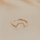 Gold ring on a beige marble surface