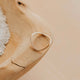 Gold ring on a wooden surface with a natural background