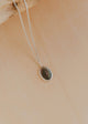 Necklace with a pendant on a beige background