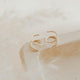 Close-up of tiny twist earrings