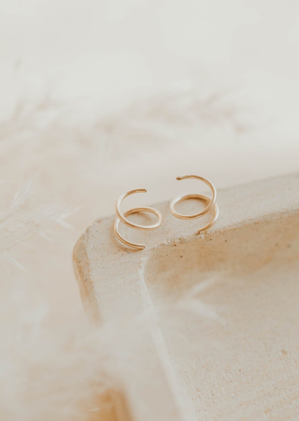 Close-up of tiny twist earrings