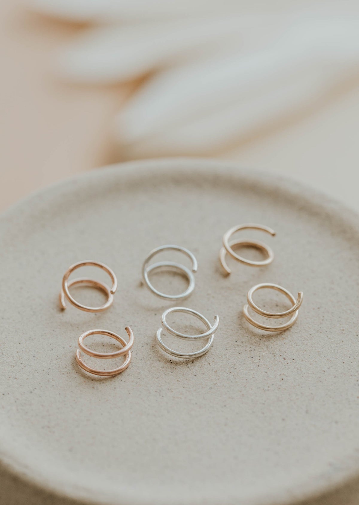 Close-up of Hello Adorn tiny twist earrings