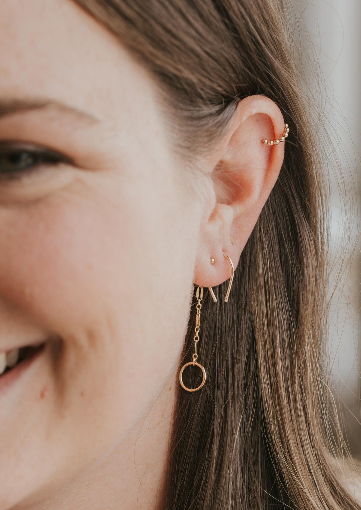 14k gold fill tiny horseshoe threader earrings styled with beaded gold ear cuff and backdrop earring by Hello Adorn