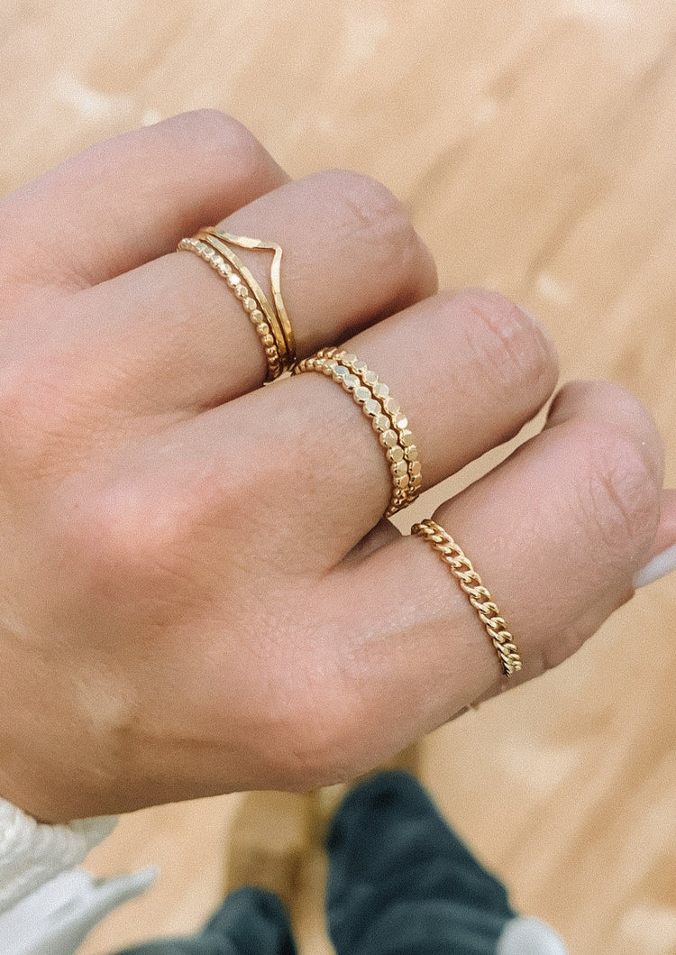 A ring stack curated by Hello Adorn featuring a chain ring in the Dani Chain Ring style paired with stackable rings in Confetti Ring style and a 3 ring pack.