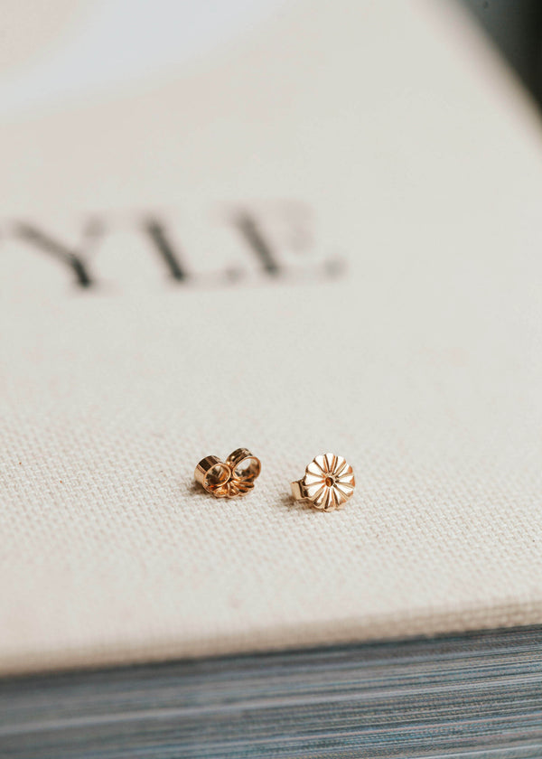 A pair of earring backs shown in 4k gold fill created by Hello Adorn.