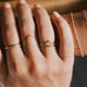 Ring stack idea created by Hello Adorn with valley trio which comes in a ring set of 3 with a thin ring, gold textured ring, and a curved ring styled with a statement ring in the swell ring style, another thin ring, a beaded ring, and permanent bracelet.
