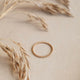 A textured ring handmade by Hello Adorn in the beaded ring style shown in 14k gold fill.