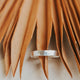 A hammered Sterling Silver statement ring by Hello Adorn in Cigar Band style measuring 3.5 mm thickness.