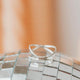 A wire wrapped ring shown in sterling silver jewelry by Hello Adorn that can be added to a ring stack or used as a statement ring.