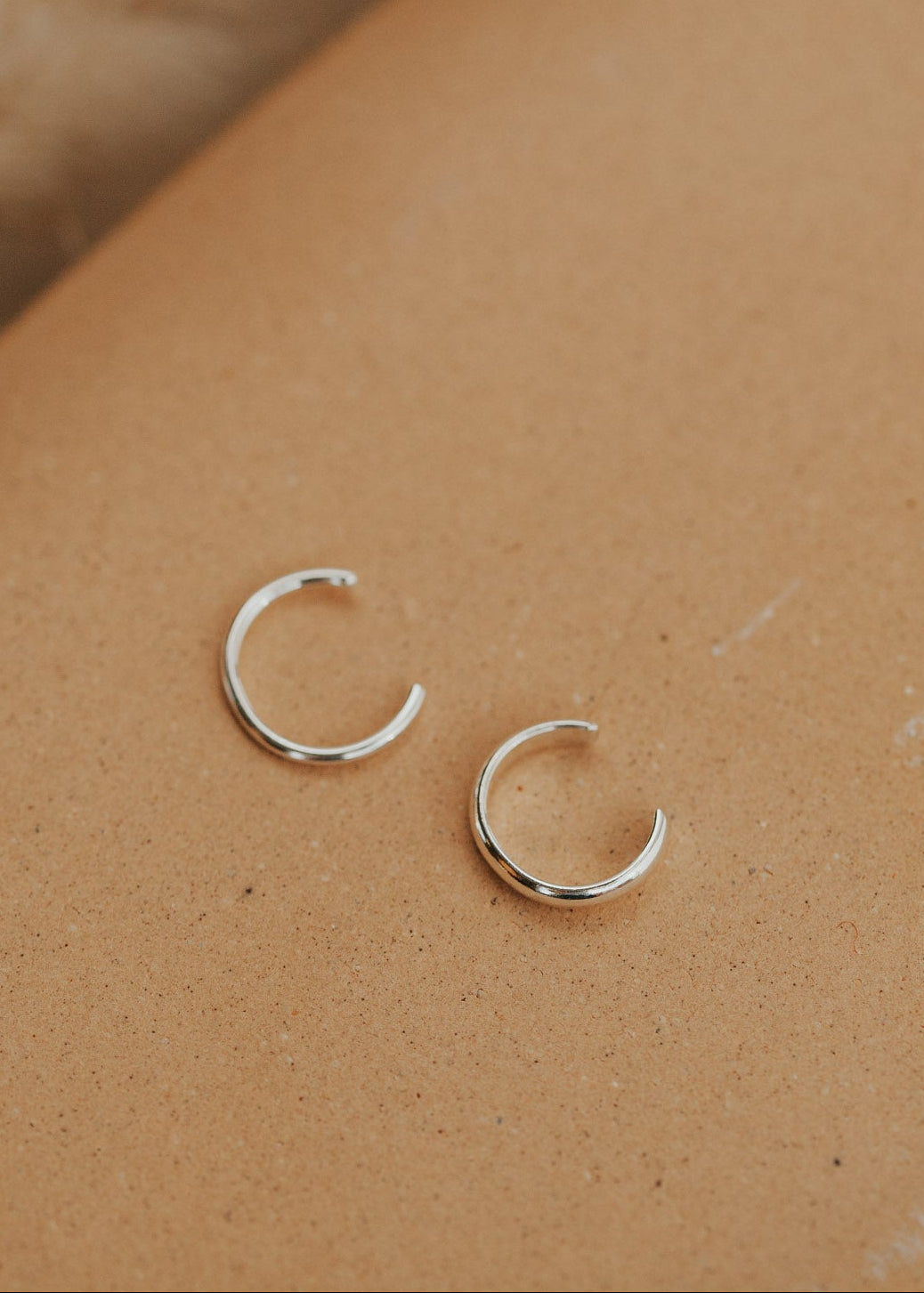 A silver ear cuff pair for people looking for earrings for no piercings, Hello Adorn created this Ear Cuff Duo that includes a thin ear cuff duo and a thick ear cuff duo.