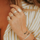14kt Gold Fill Hand Chain Ring on a young model with other ring stacks.