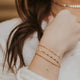A beautiful young lady wearing 14kt Gold Fill stack bracelets.