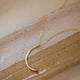 The mini-moon pendant necklace handmade by Hello Adorn made with a crescent moon pendant attached to a chain necklace, create a statement necklace to add to your necklace layering styles.