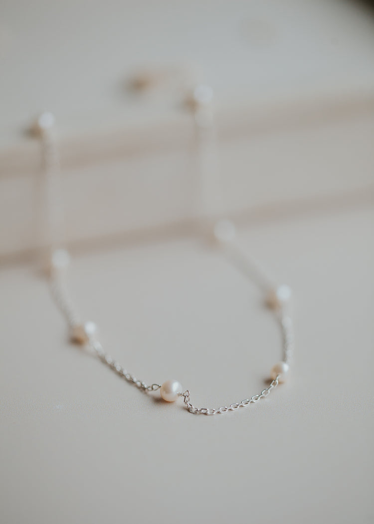 A Sterling Silver pearl anklet.