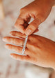 How to use a ring sizer by Hello Adorn shown with a ring stack of squiggle ring, teeny-tiny band, tiny hammered ring, and dani chain ring.