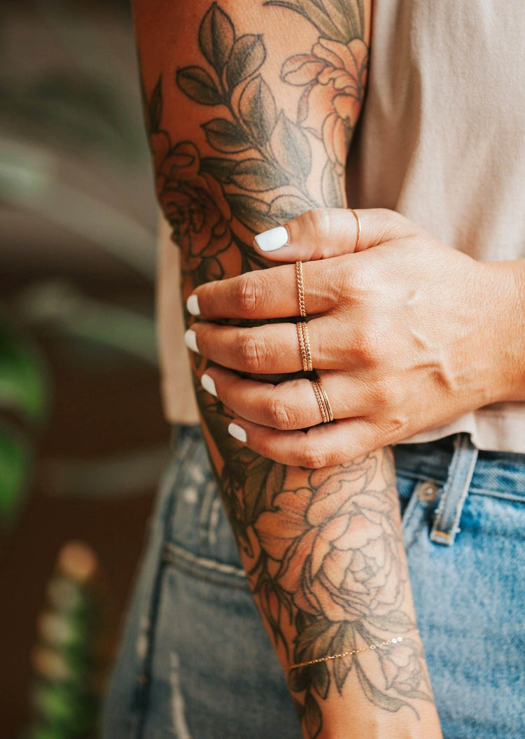 A gold ring stack curated by Hello Adorn using rings from their stacking rings collection, this stack features a chain ring in the Dani Chain Ring style.