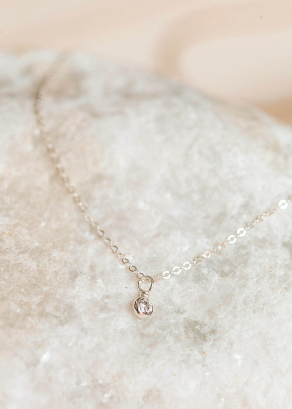 A sterling silver stone necklace handmade by Hello Adorn featuring a white stone in a bezel setting necklace diamond.