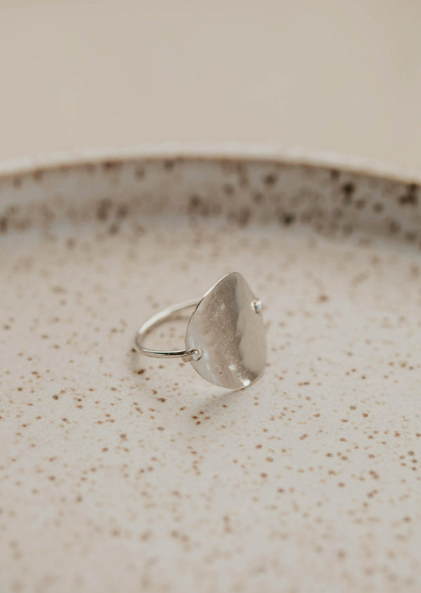 A silver statement ring created to look like a moon ring, this ring started as a circle ring and then was hammered to create this beautiful textured ring by Hello Adorn.